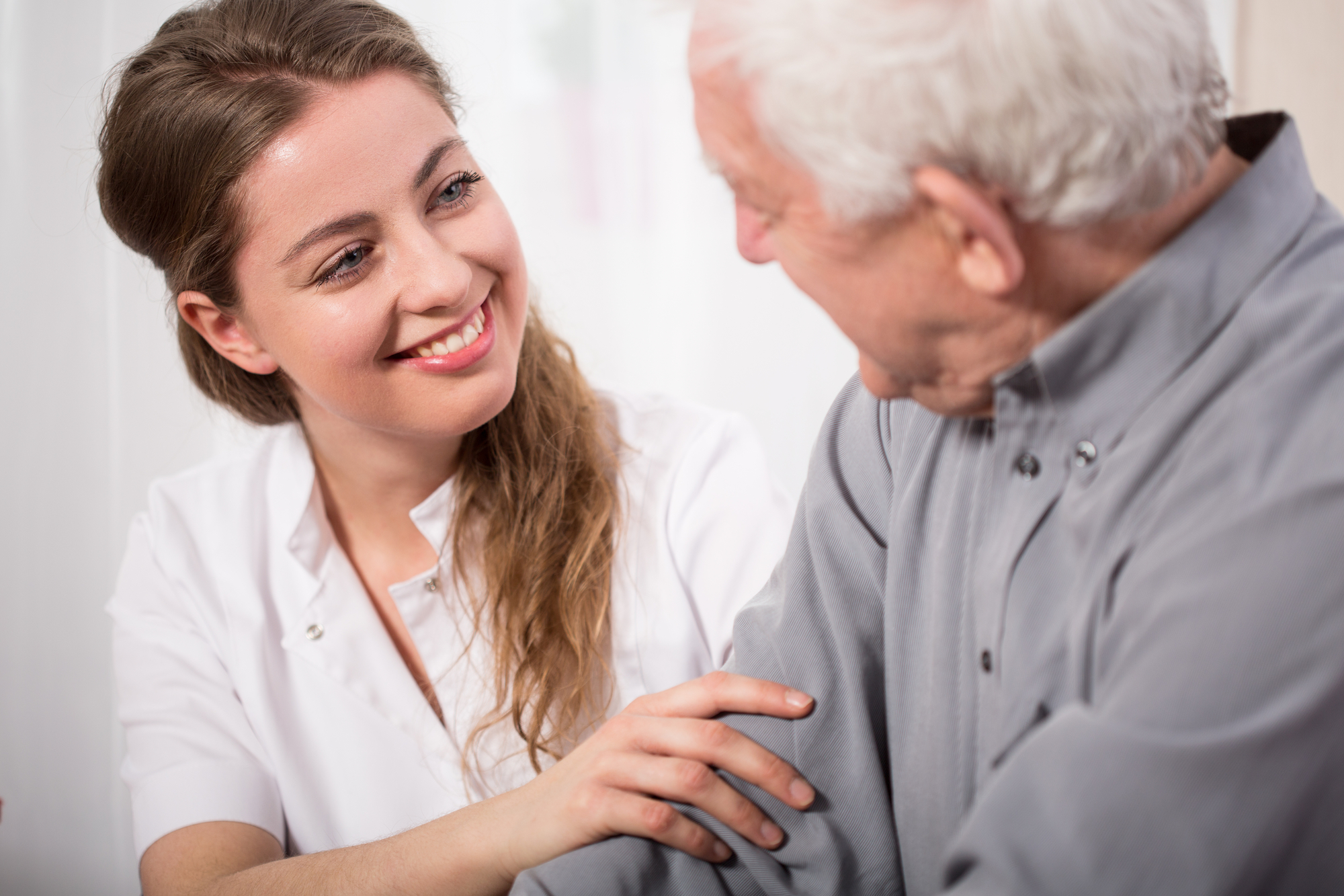 Caregiver Assisting  A Senior Man